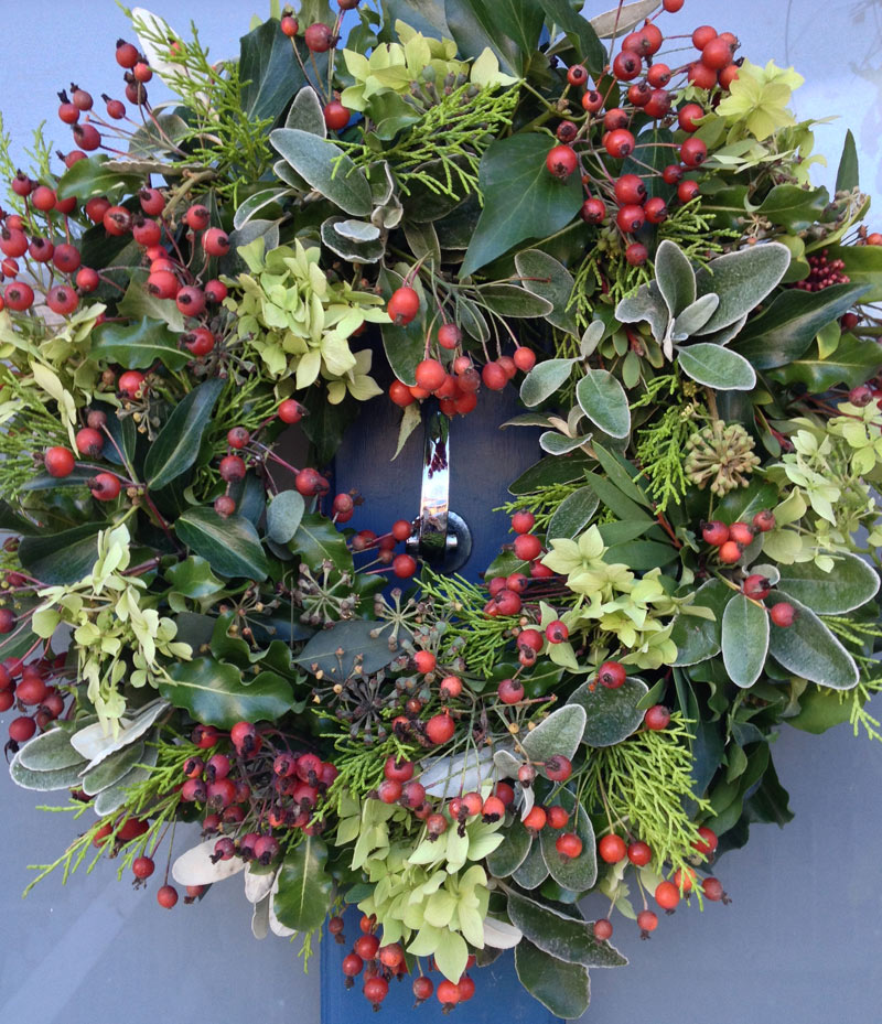 Christmas door wreath with rose hips, Hydrangea, Senecio, ivy and fir
